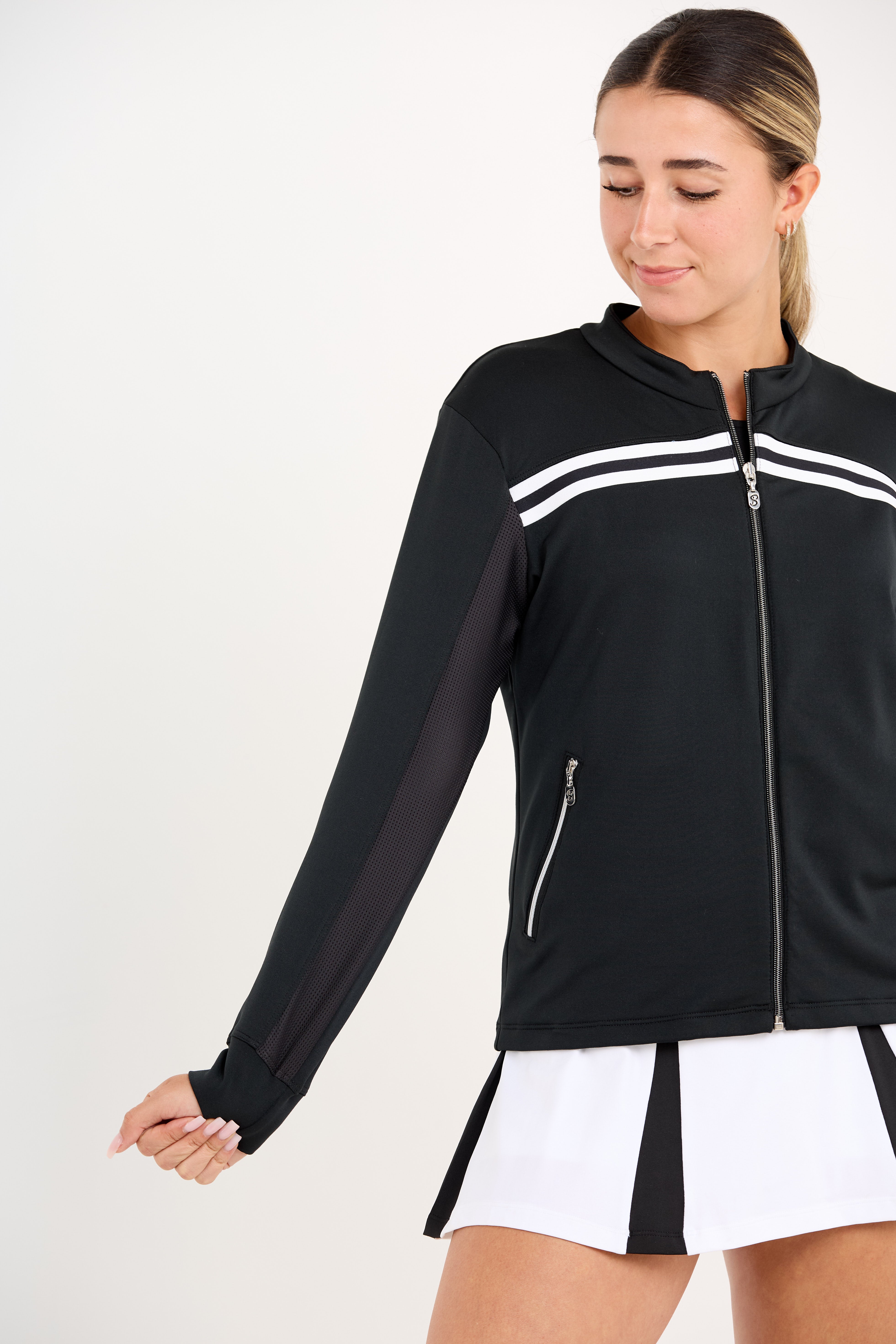 Black women's golf and tennis jacket with zipper, and mesh inserts close up view of sleeve