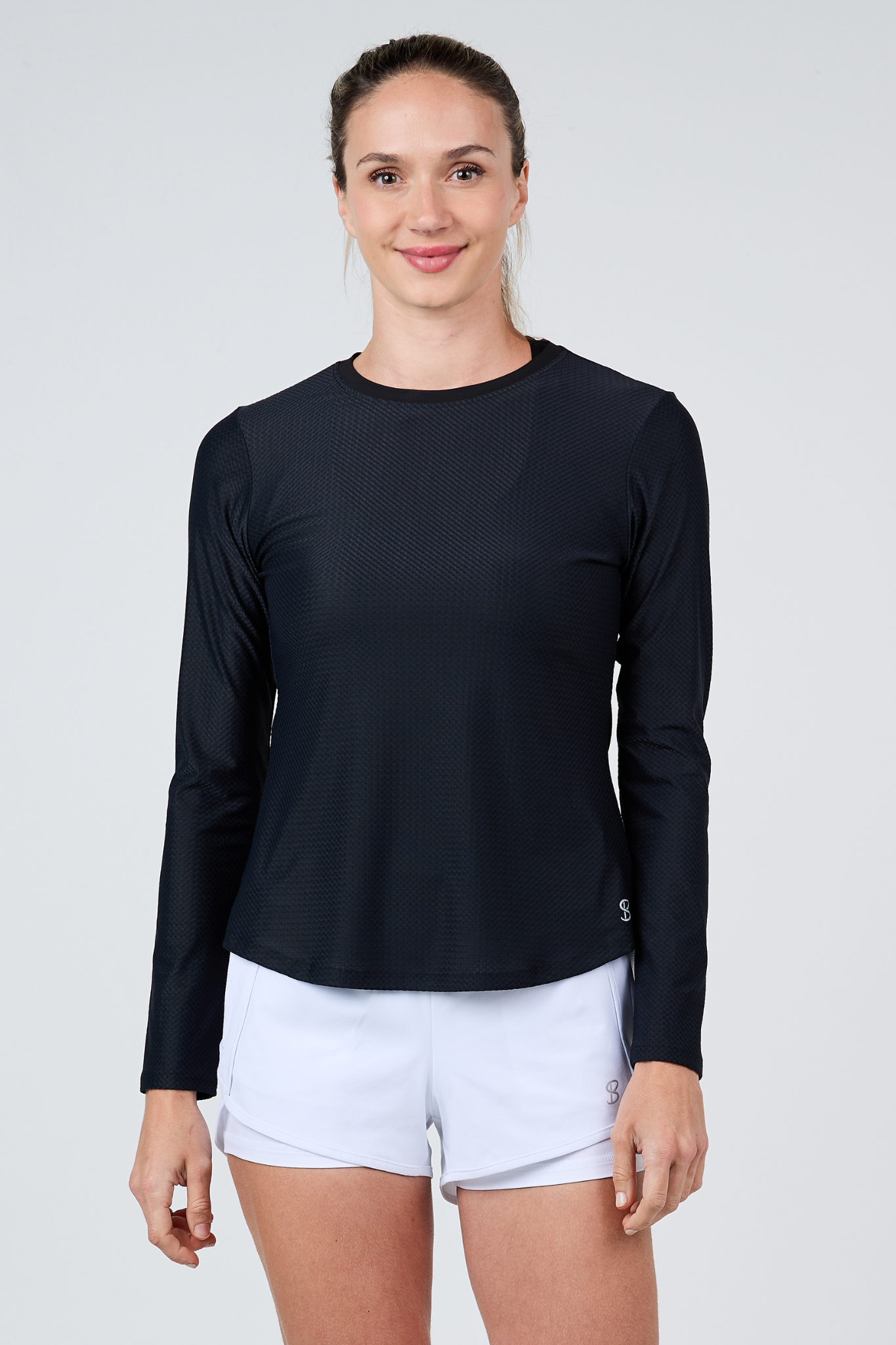 Women's Staples Mesh Long Sleeve Tennis Top in Black by Sofibella, front view on model