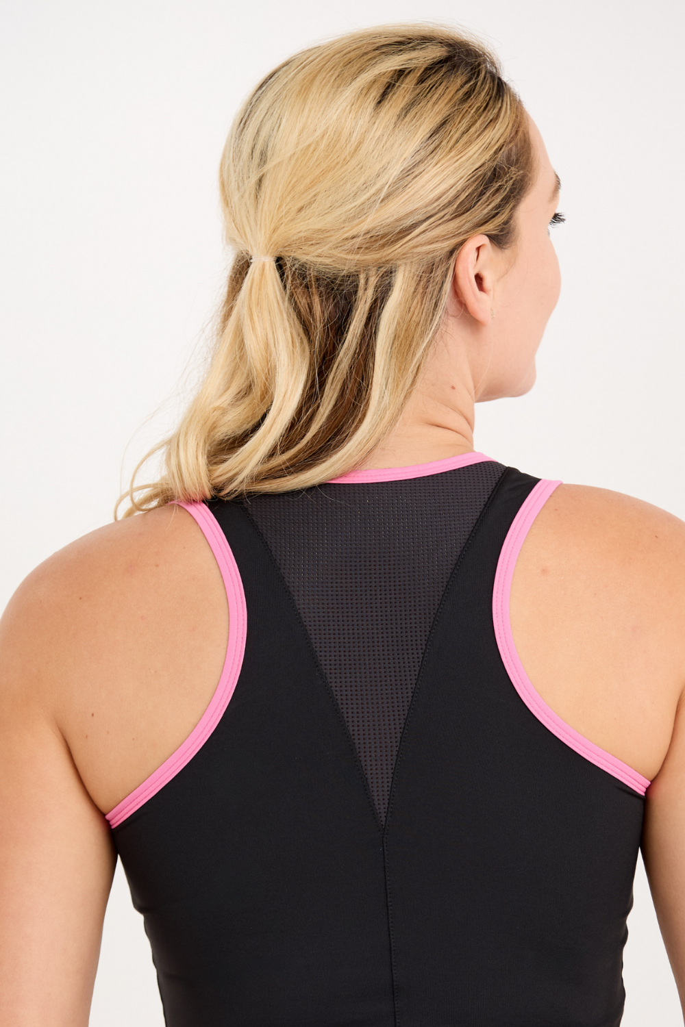 Sofibella Women's Black Racerback Tennis Tank Top with Pink Trim, close up back view on model