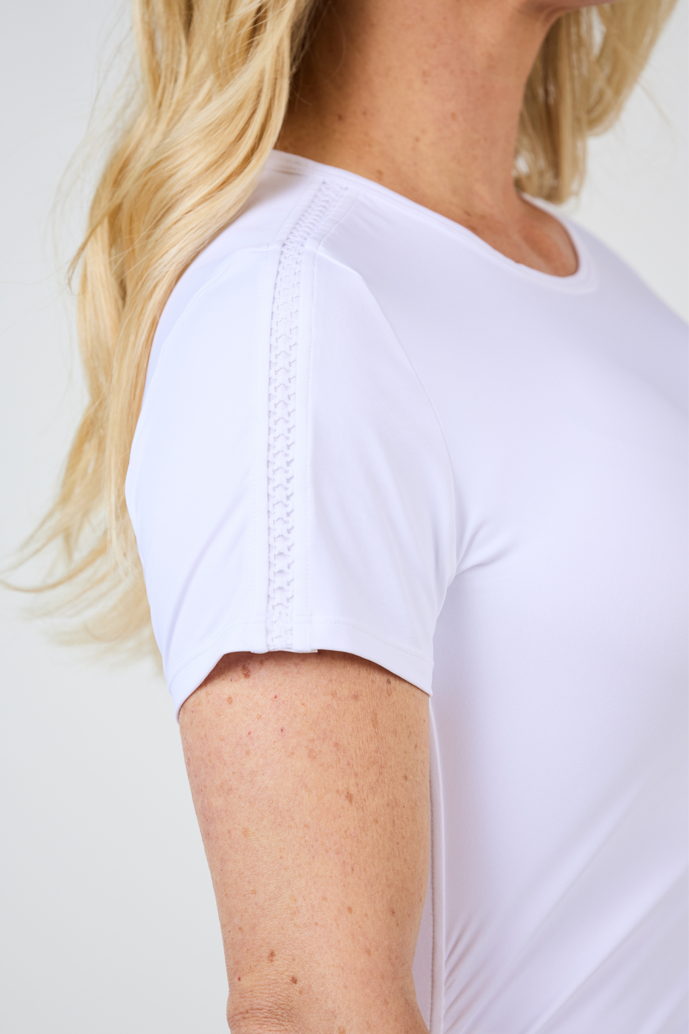 Tres Blanc Women's Short Sleeve Tennis Top by Sofibella, trellis detail on sleeve
