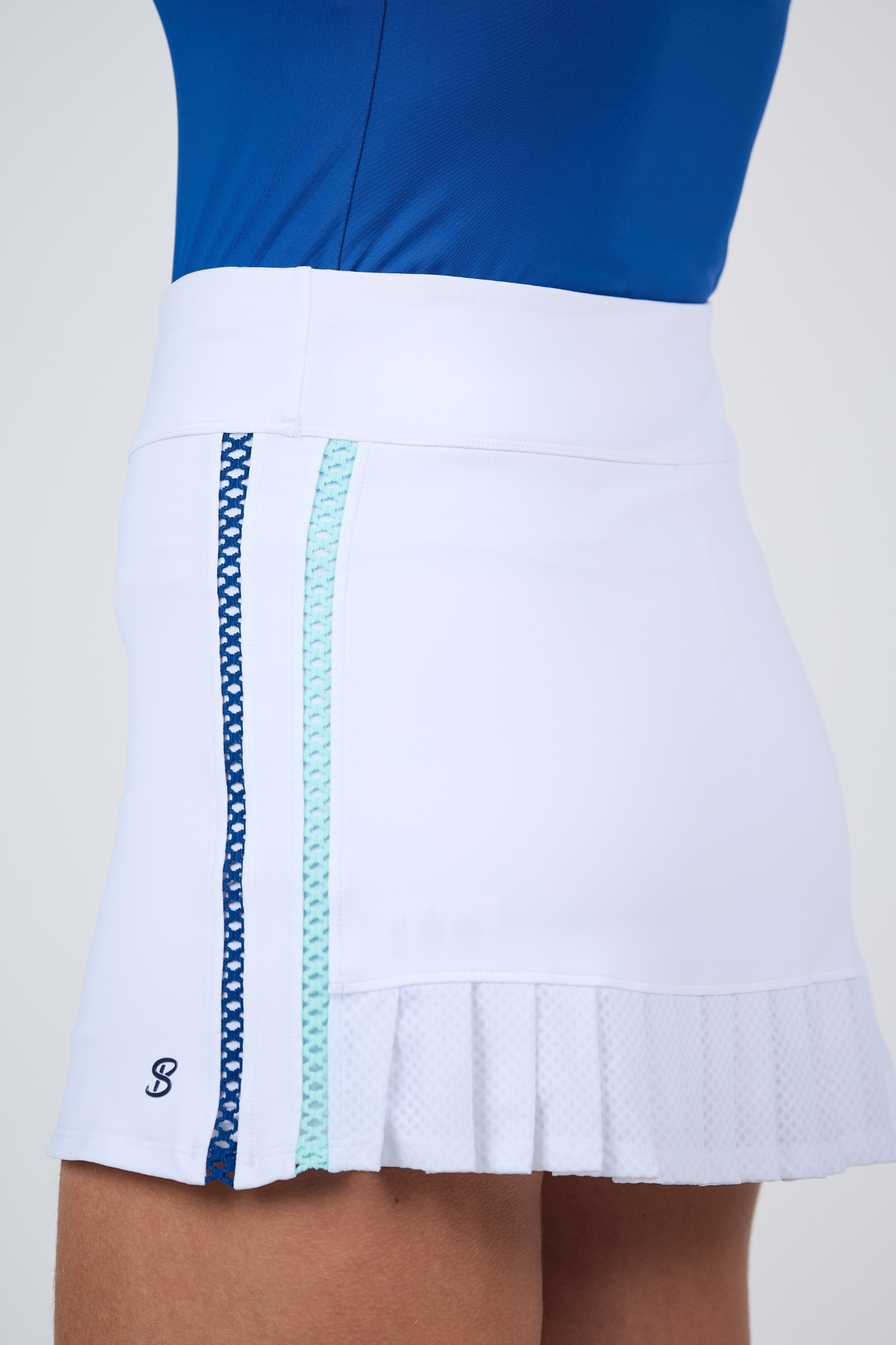 Perfect Storm 13” White Pleated Tennis Skort by Sofibella - close up side view on model