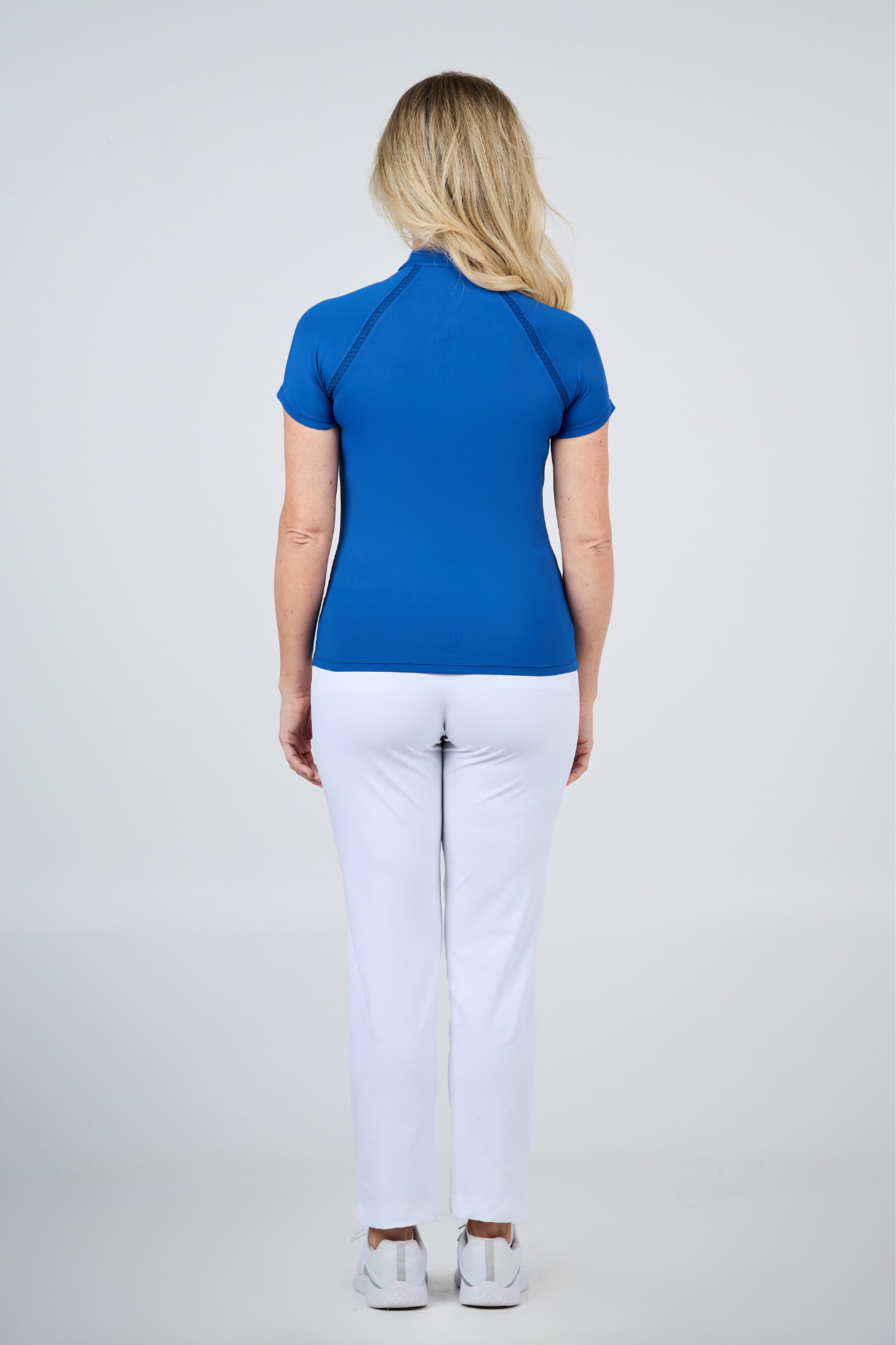 Women's True Blue Zippered Raglan Short Sleeve Golf Top by Sofibella - back view on model