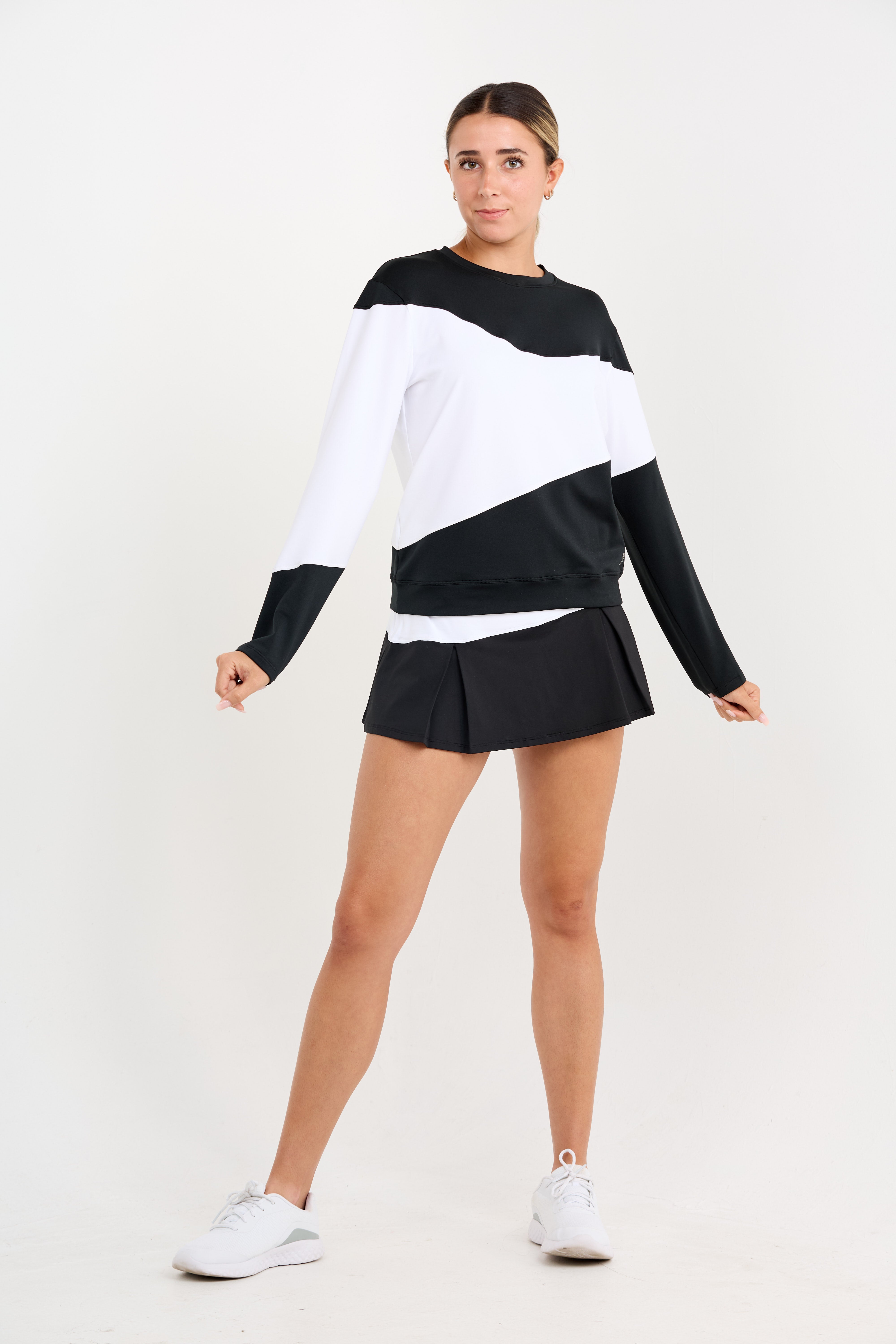 Women's long sleeve tennis pullover in black and white, front view