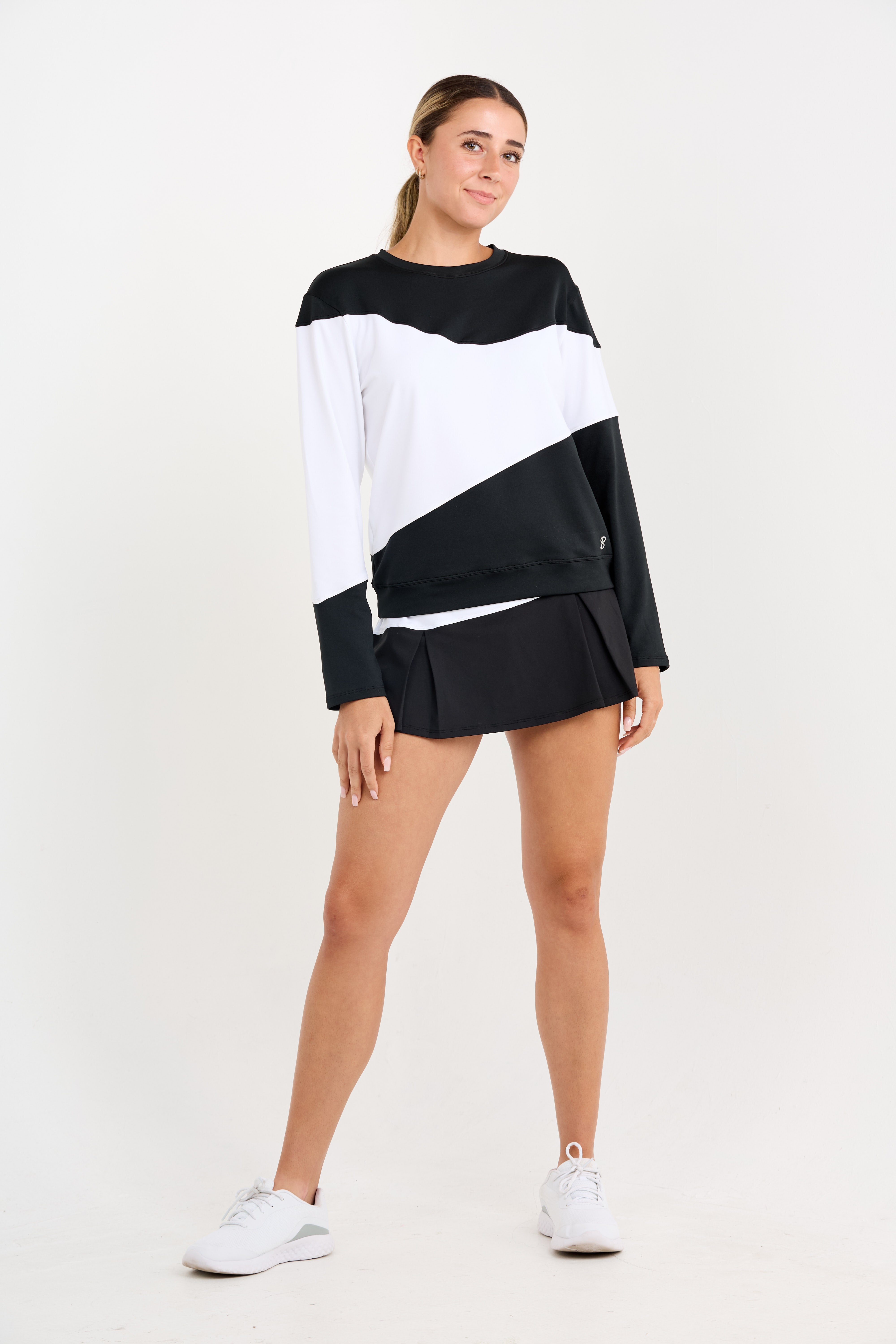 Women's long sleeve tennis pullover in black and white, front view