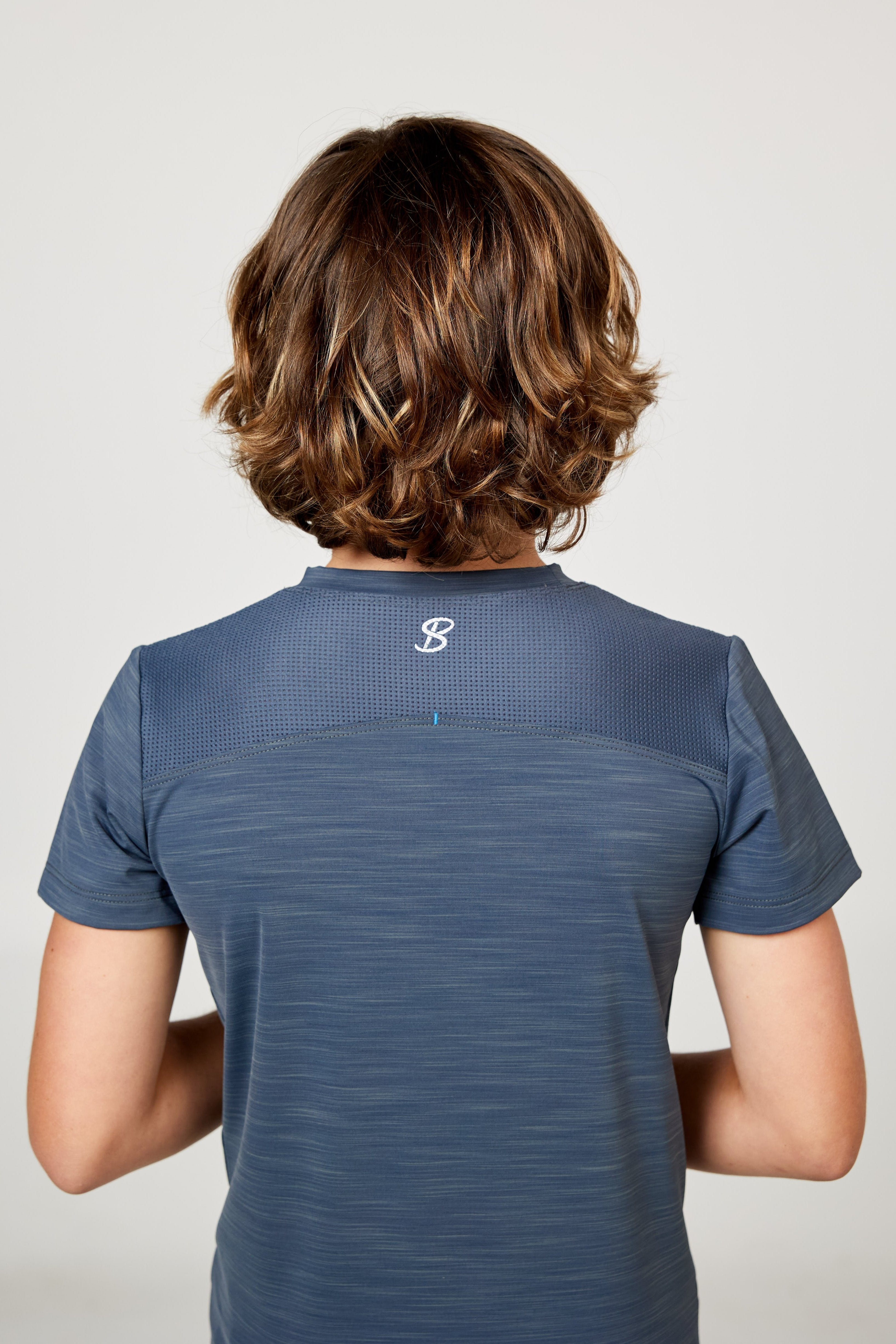 Charcoal boys' short sleeve tennis top by Sofibella, back view on model