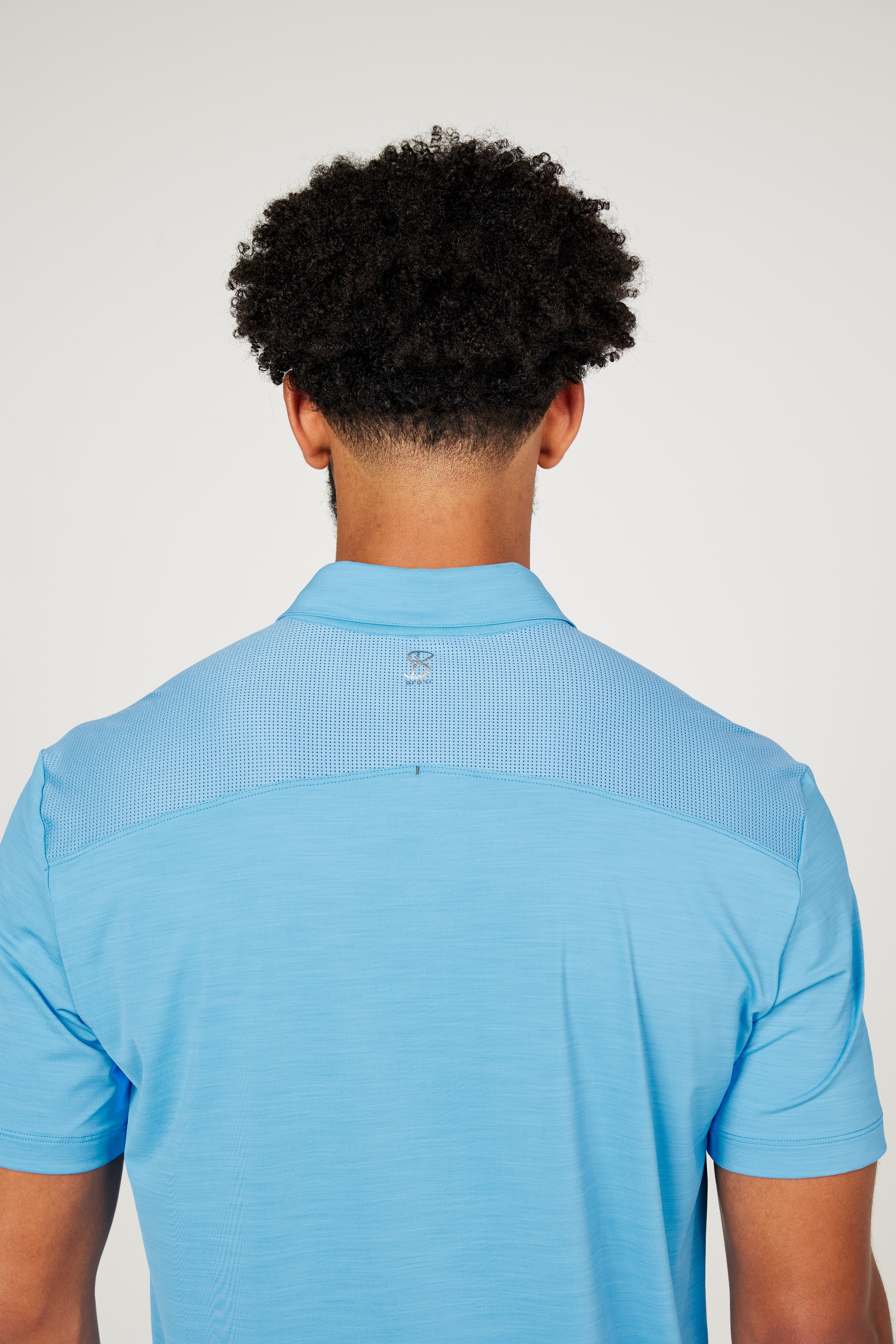 Men's Energy Short Sleeve Neo Blue Polo Tennis Top by Sofibella, close up back view on model
