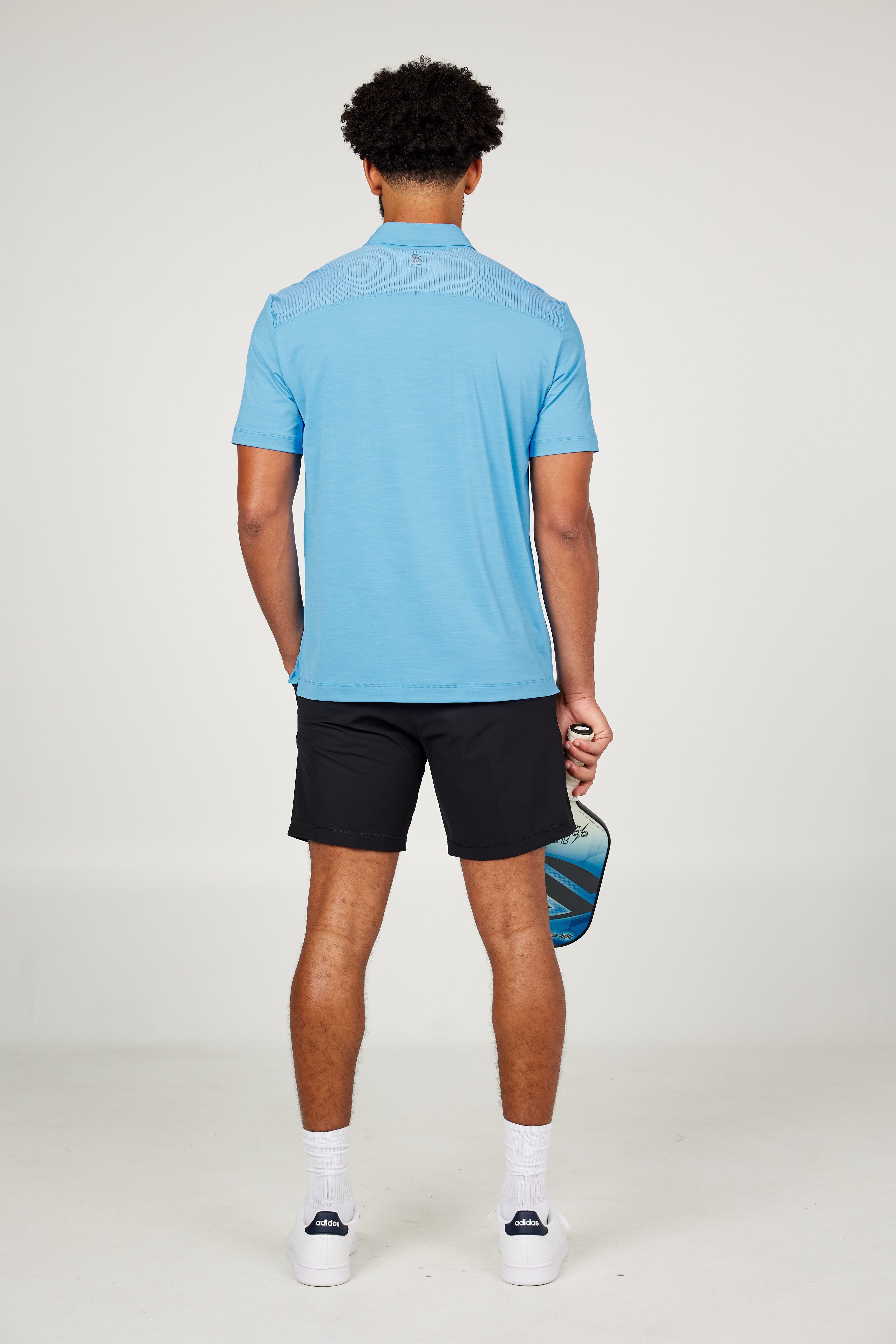 Men's Energy Short Sleeve Neo Blue Polo Tennis Top by Sofibella, back view on model