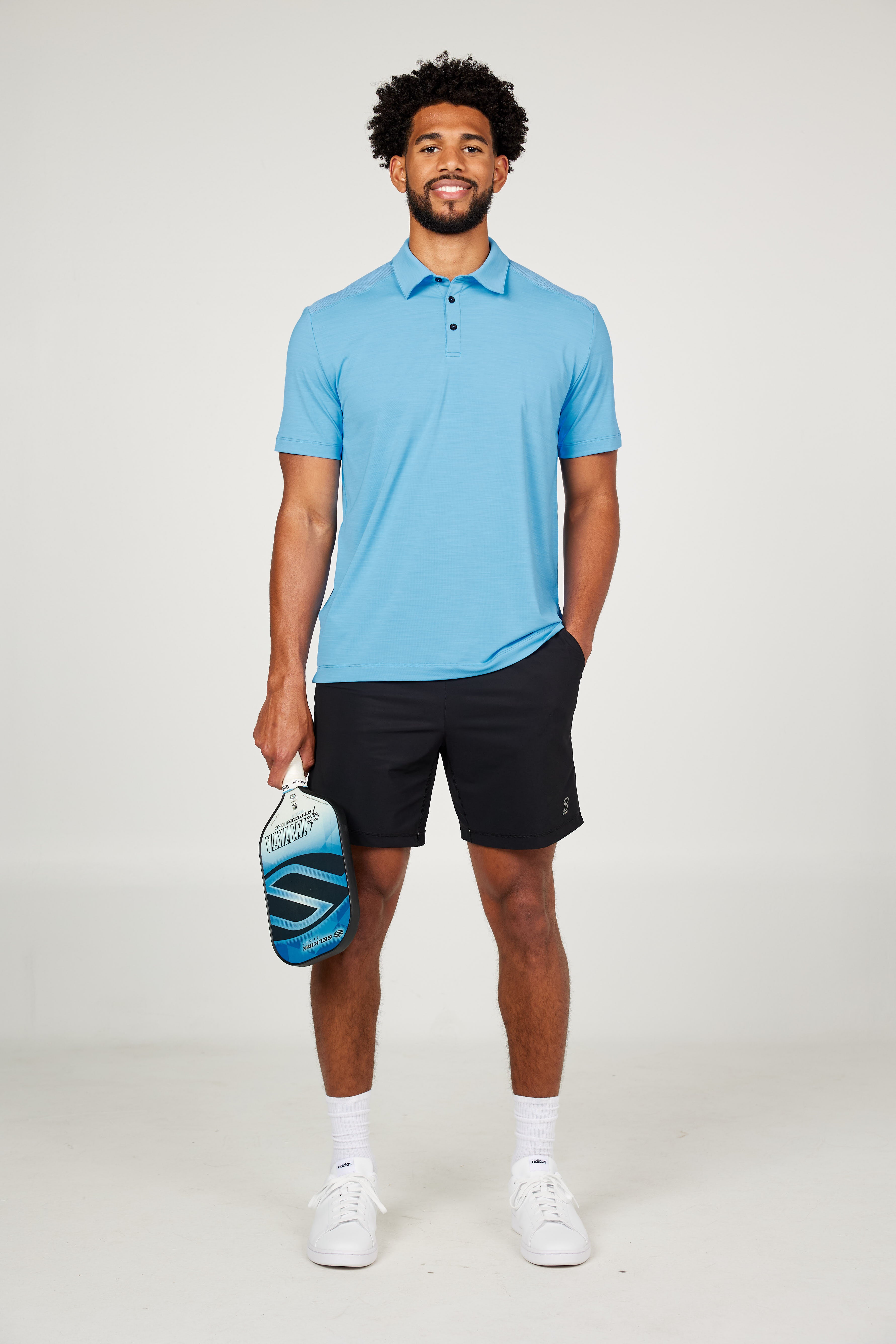 Men's Energy Short Sleeve Neo Blue Polo Tennis Top by Sofibella, front view on model