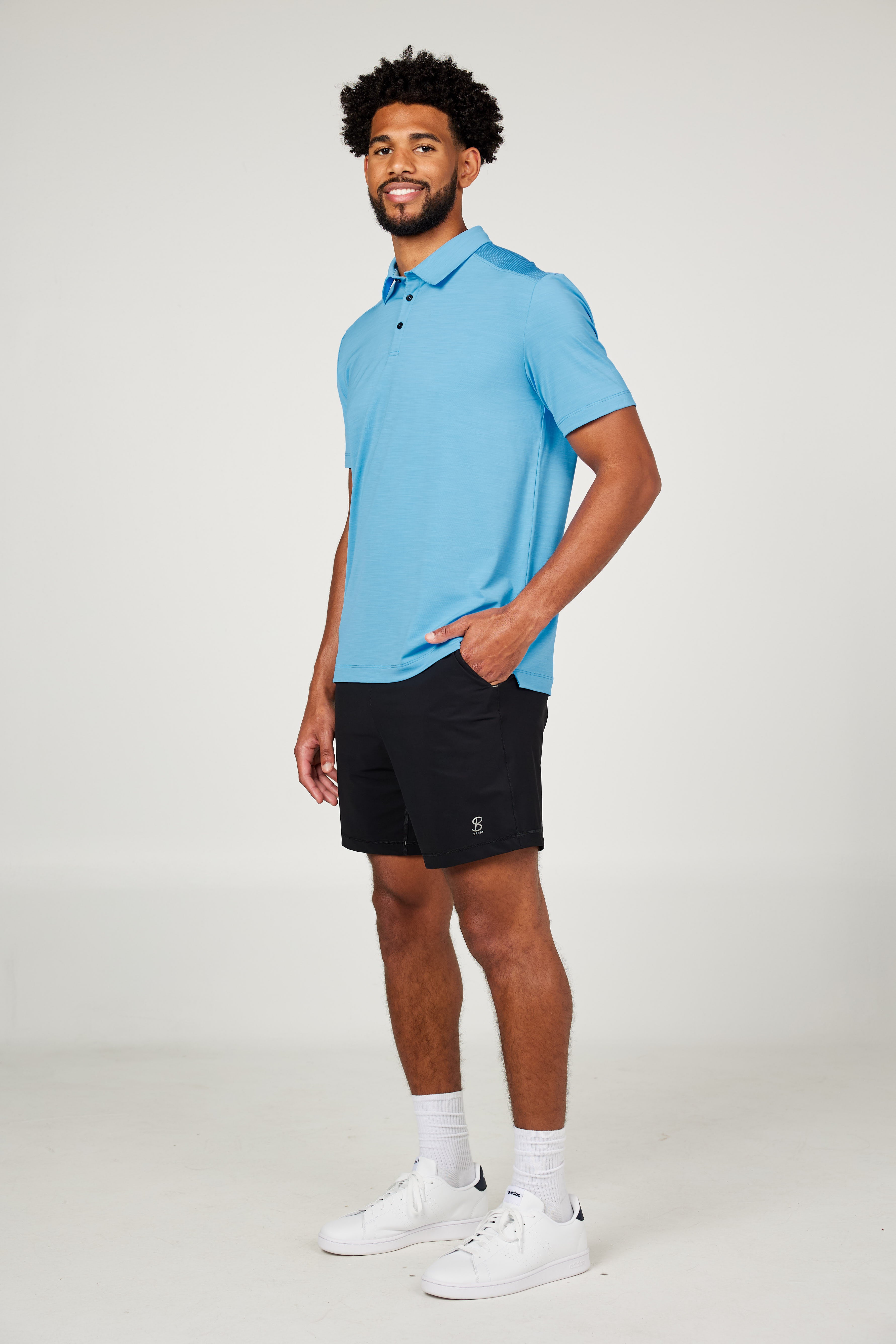 Men's Energy Short Sleeve Neo Blue Polo Tennis Top by Sofibella, front view on model