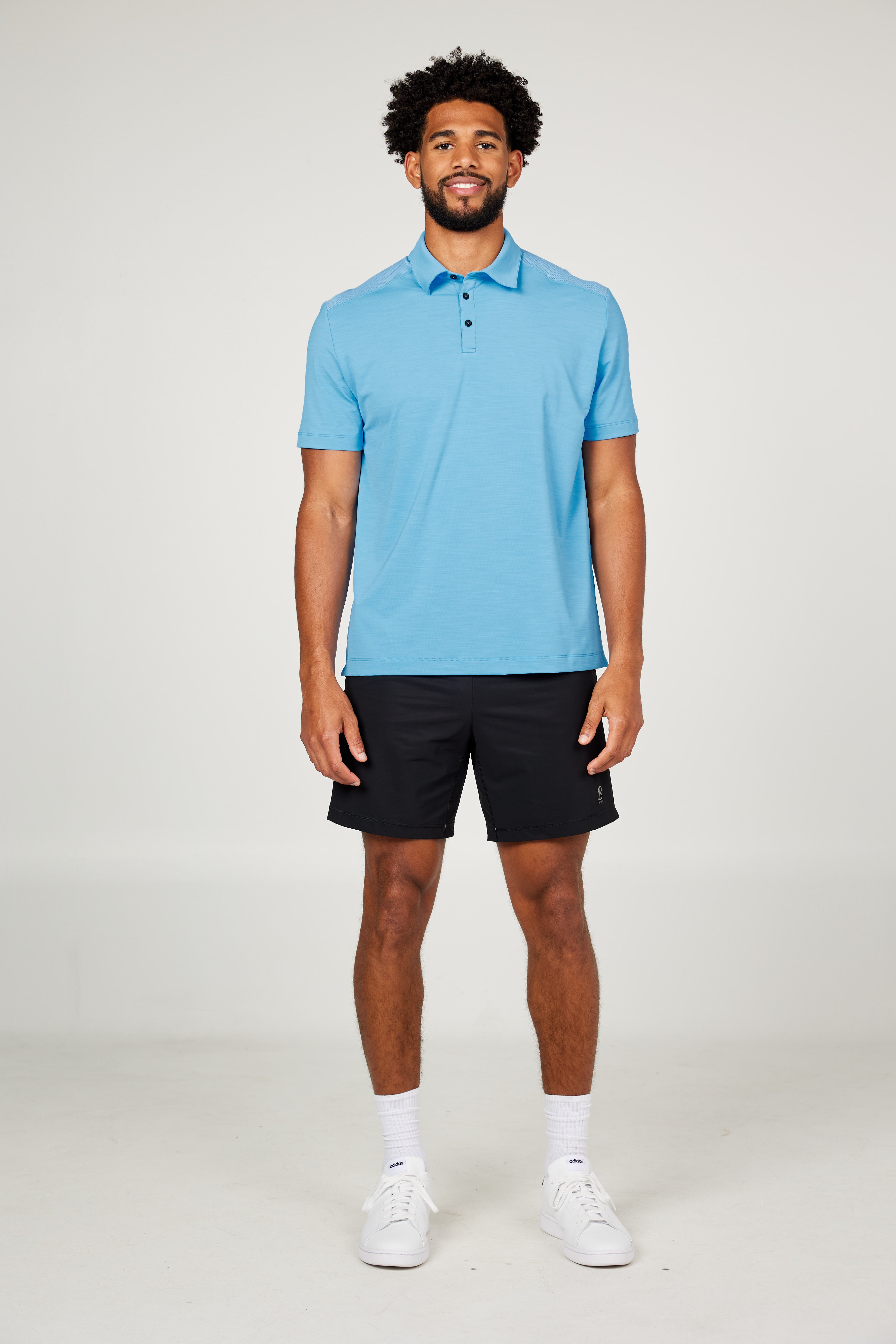Men's Energy Short Sleeve Neo Blue Polo Tennis Top by Sofibella, front view on model