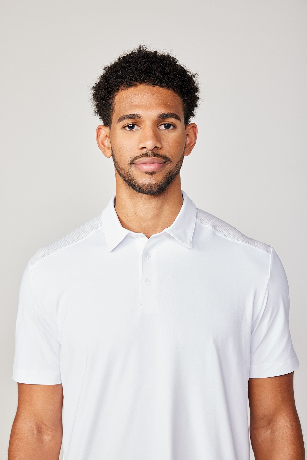 Men's Energy Short Sleeve White Polo Tennis Top by Sofibella, front view on model