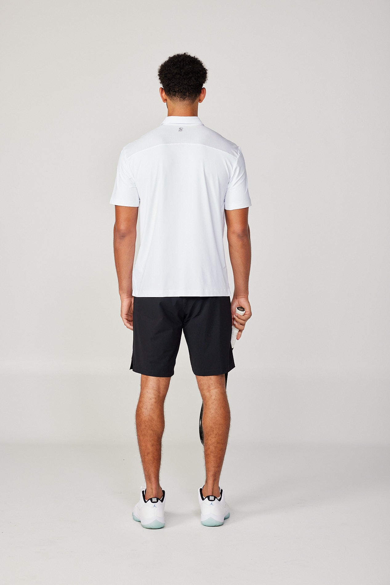 Men's Energy Short Sleeve White Polo Tennis Top by Sofibella, back view on model