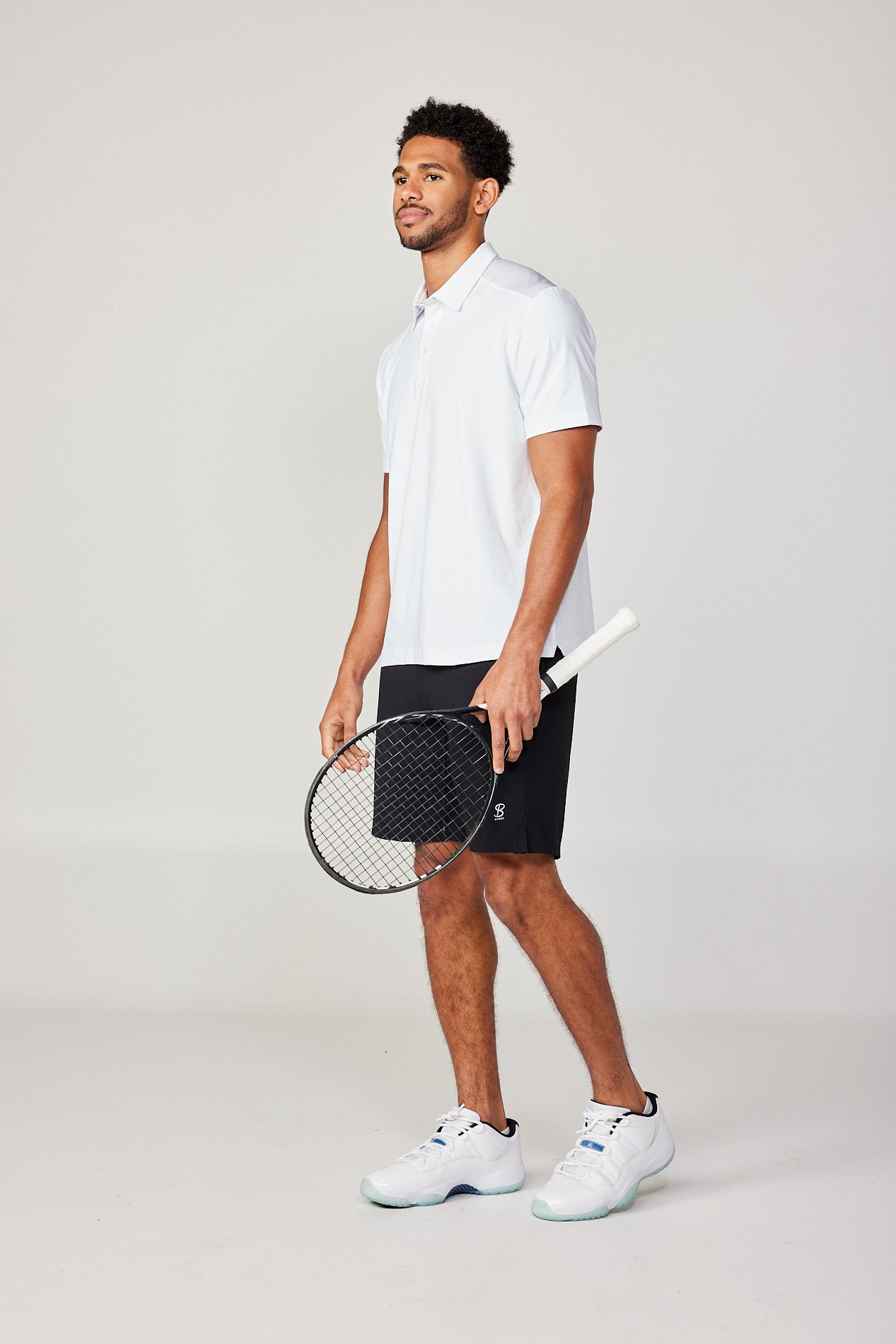 Men's Energy Short Sleeve White Polo Tennis Top by Sofibella, front view on model