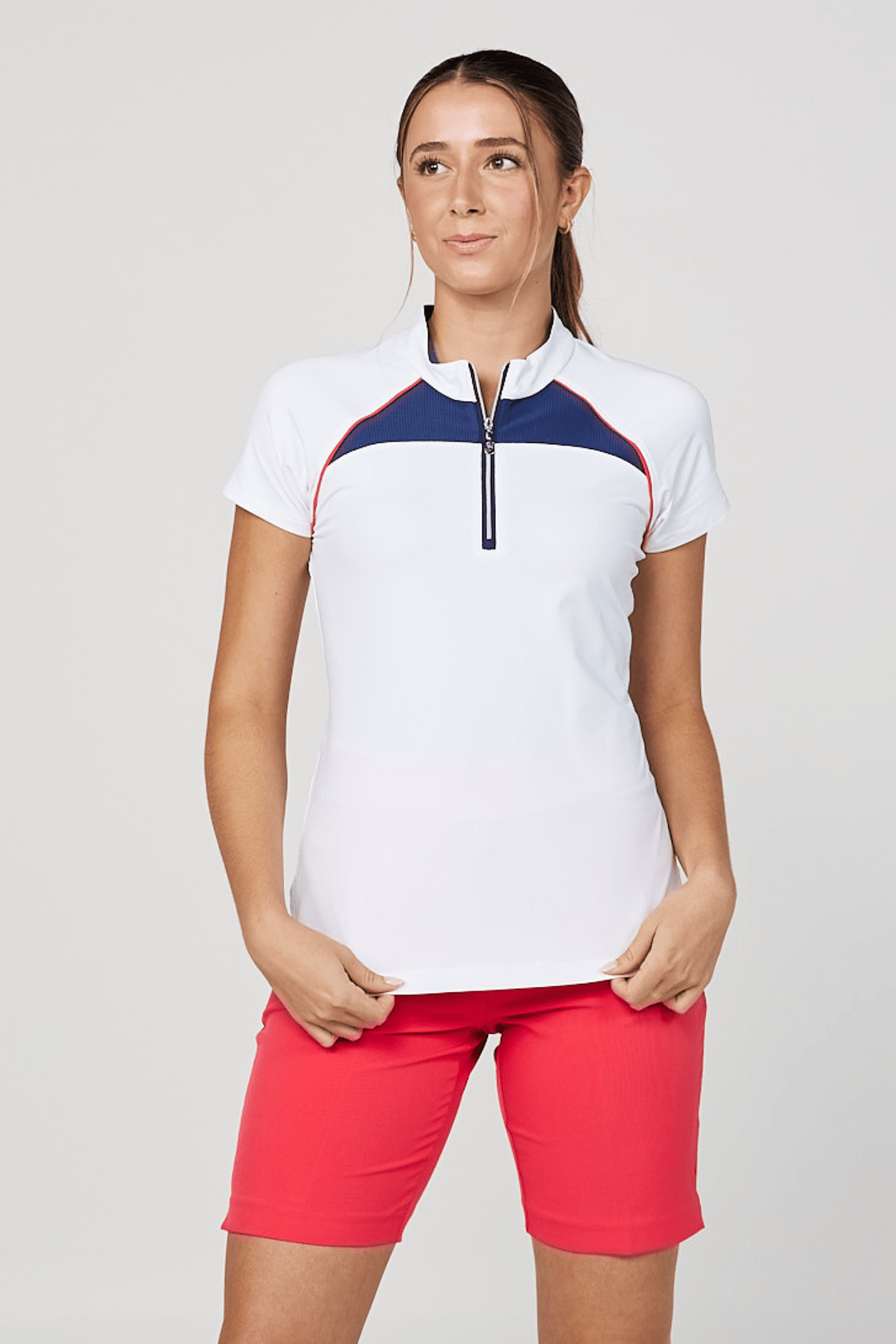 Women's White Raglan Golf Short Sleeve Zipper Top by Sofibella, close up view